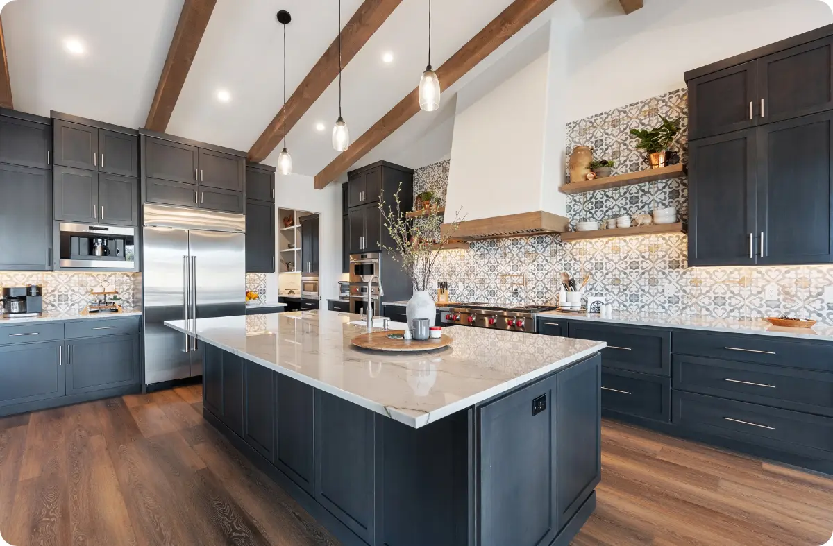 Remodeled kitchen with navy cabinetry, marble island, and pendant lighting in Keller, TX