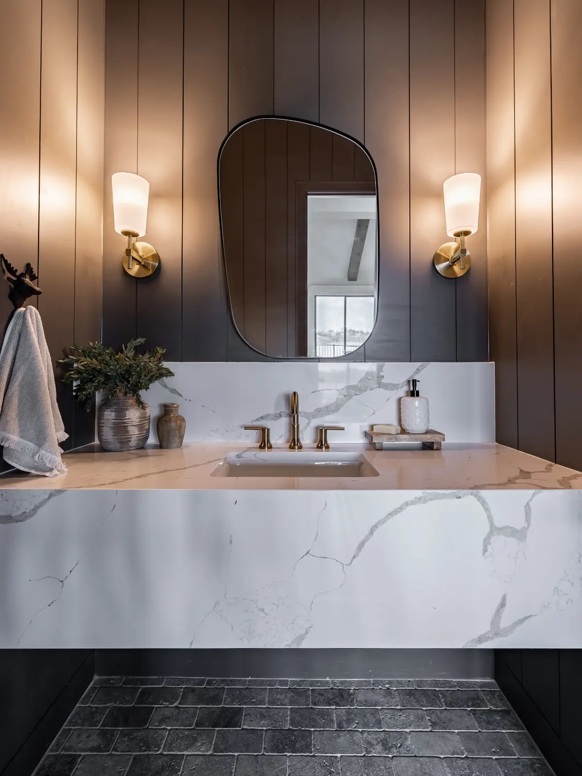 Modern bathroom vanity remodel with brass fixtures and wall sconces in Keller, TX